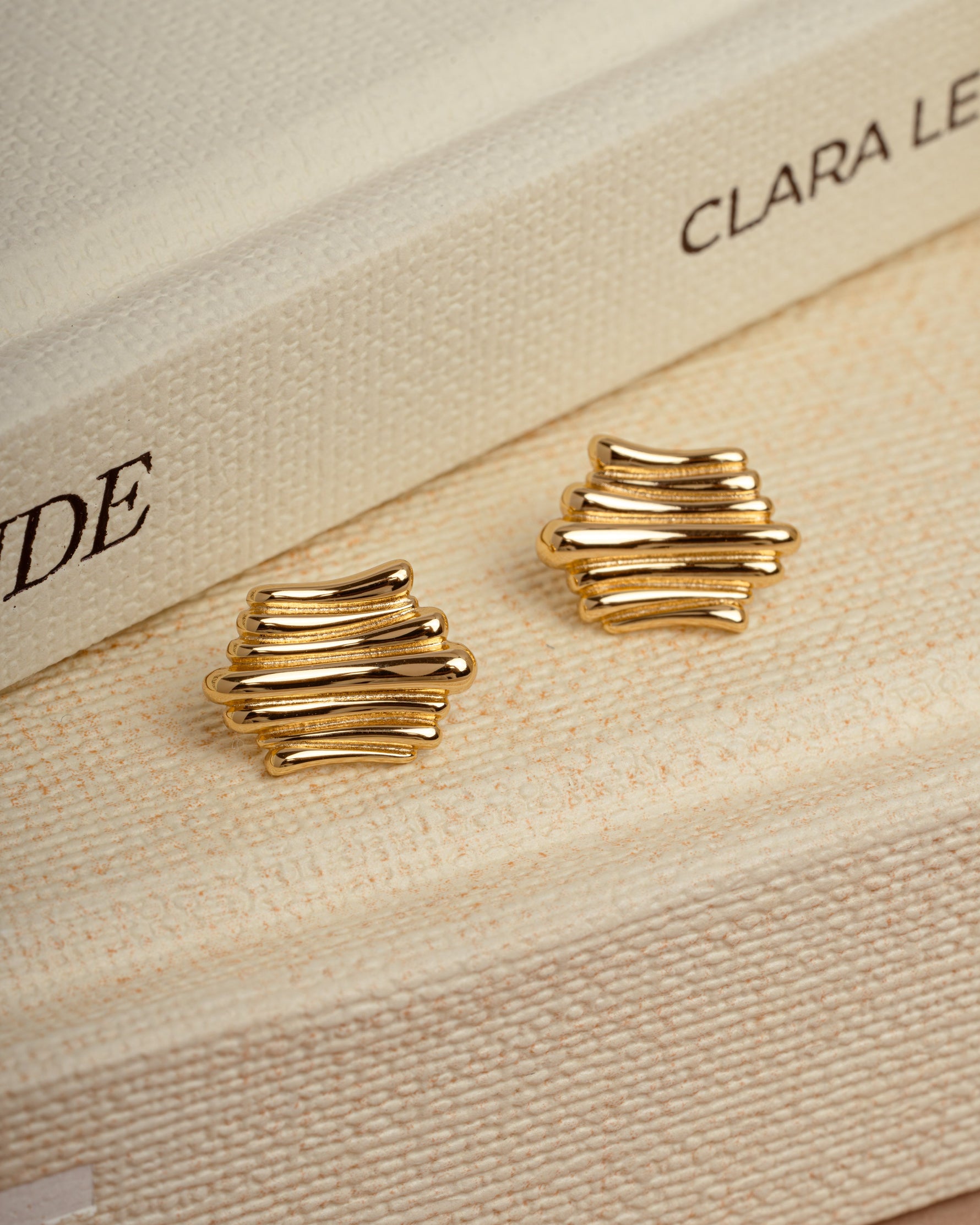 Dainty jewelry featuring unique earrings on a coffee table book