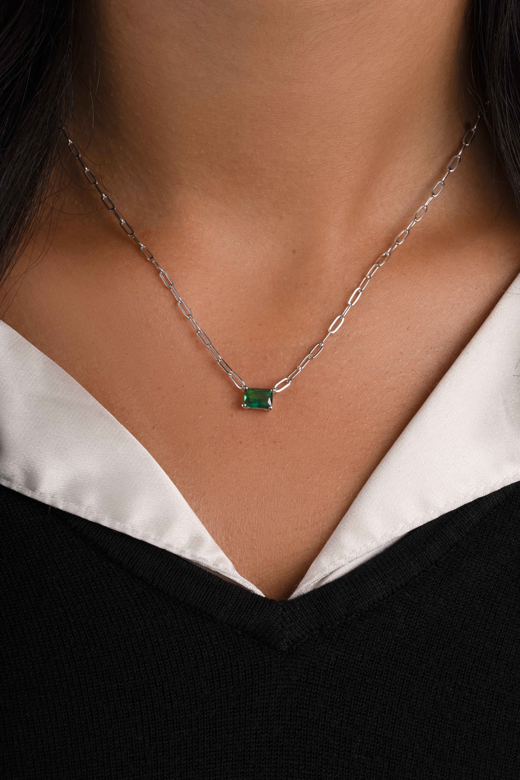 Emerald necklace with silver chain on model