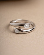 Sterling silver diamond ring on a beige surface