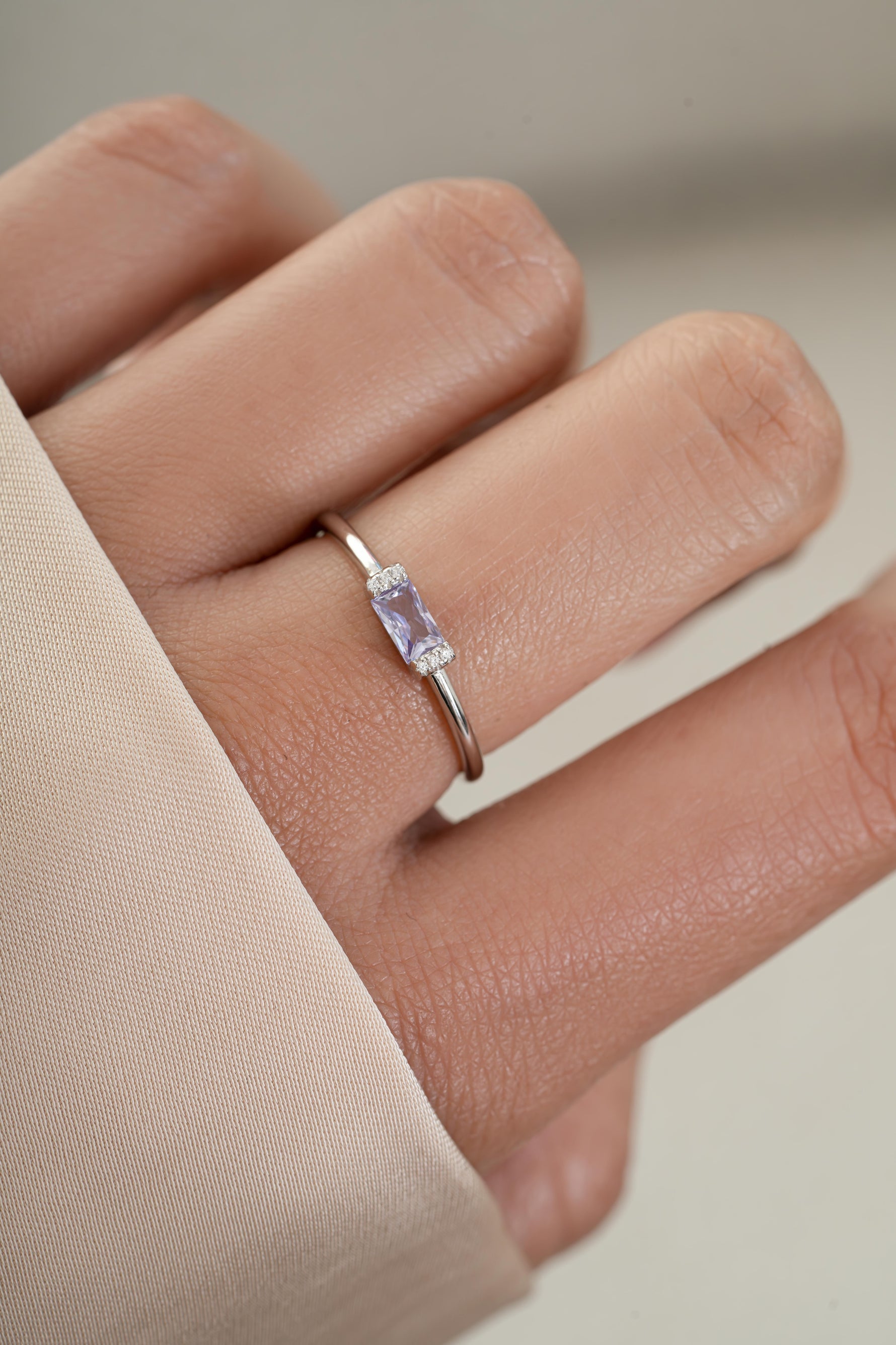 Model wearing sterling silver diamond baguette ring