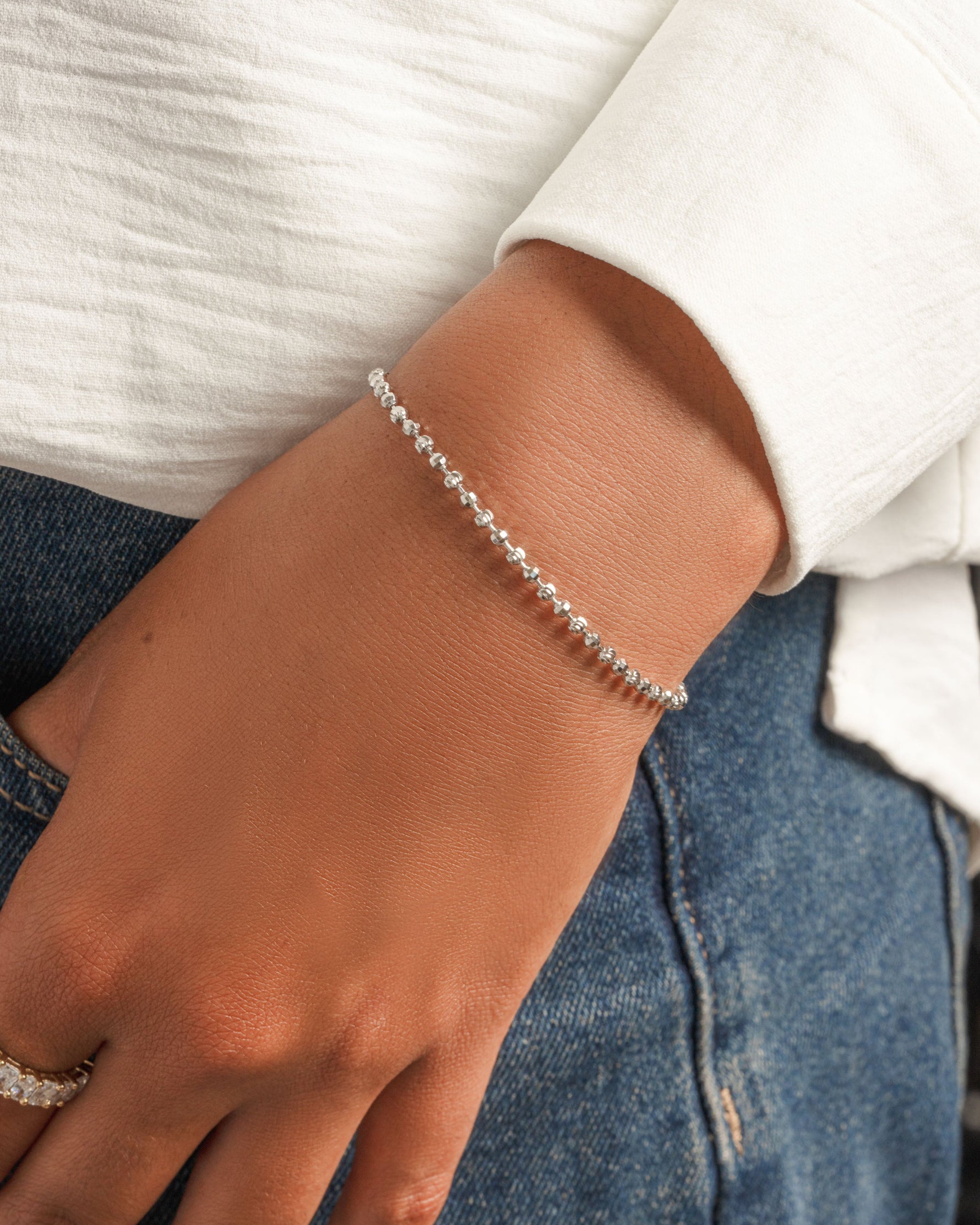 Sterling silver chain bracelet on model and diamond ring