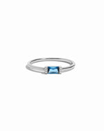 Sterling silver ring with a blue gemstone on a white background