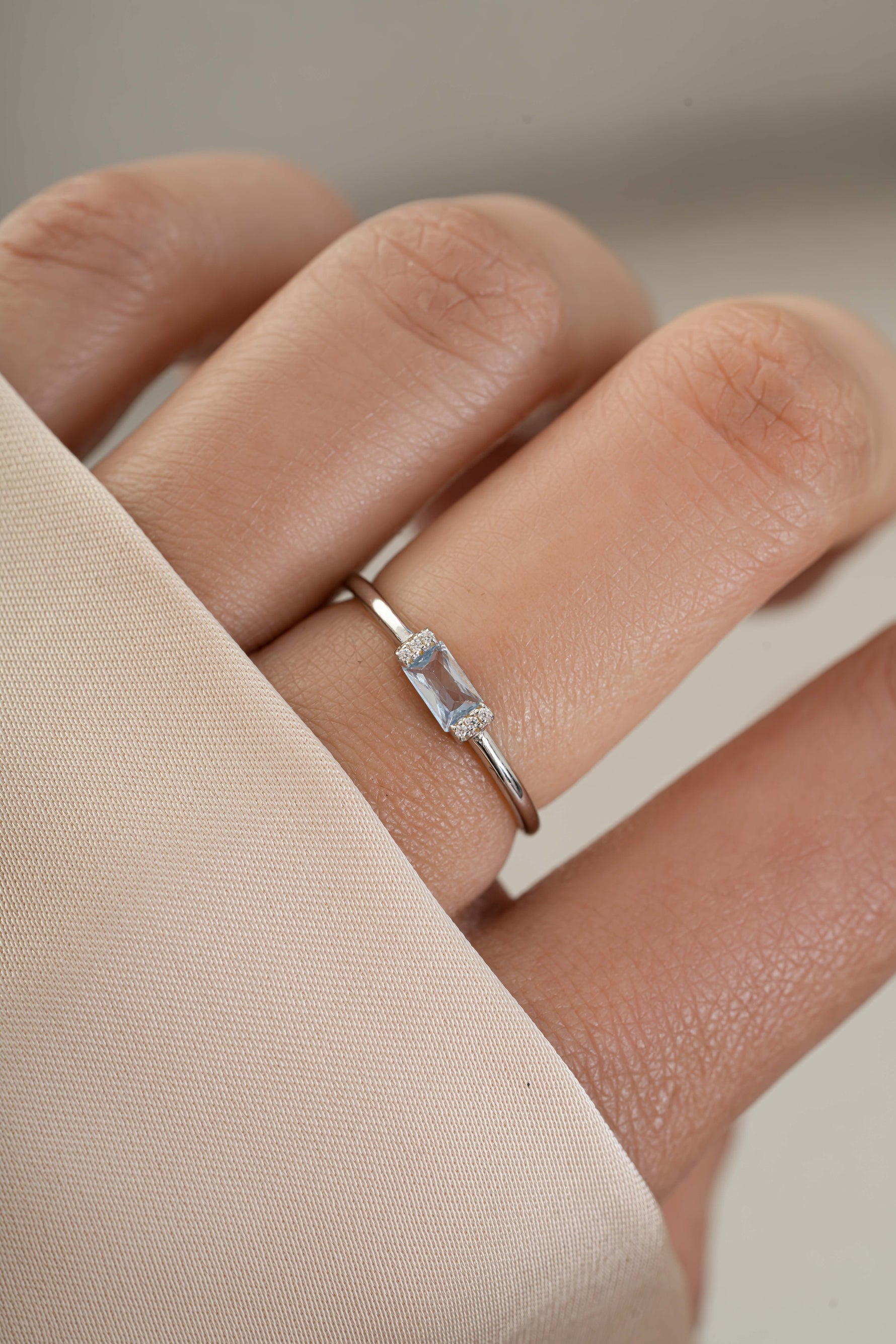 Model wearing sterling silver blue topaz baguette ring 
