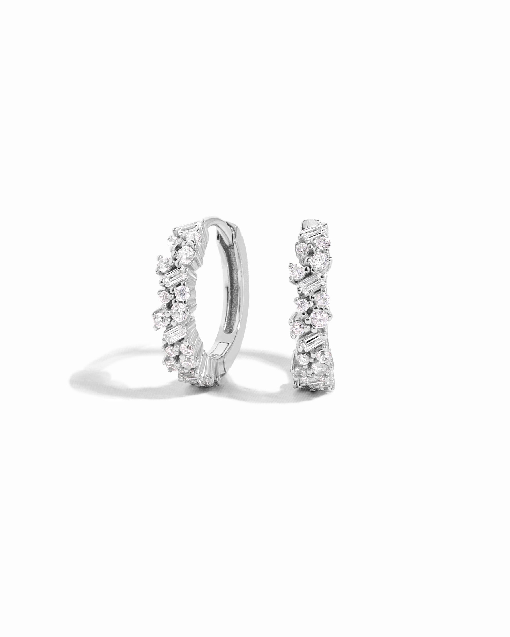 Pair of sterling silver diamond hoop earrings on a white background