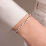 model wearing dainty silver stacking bracelet 