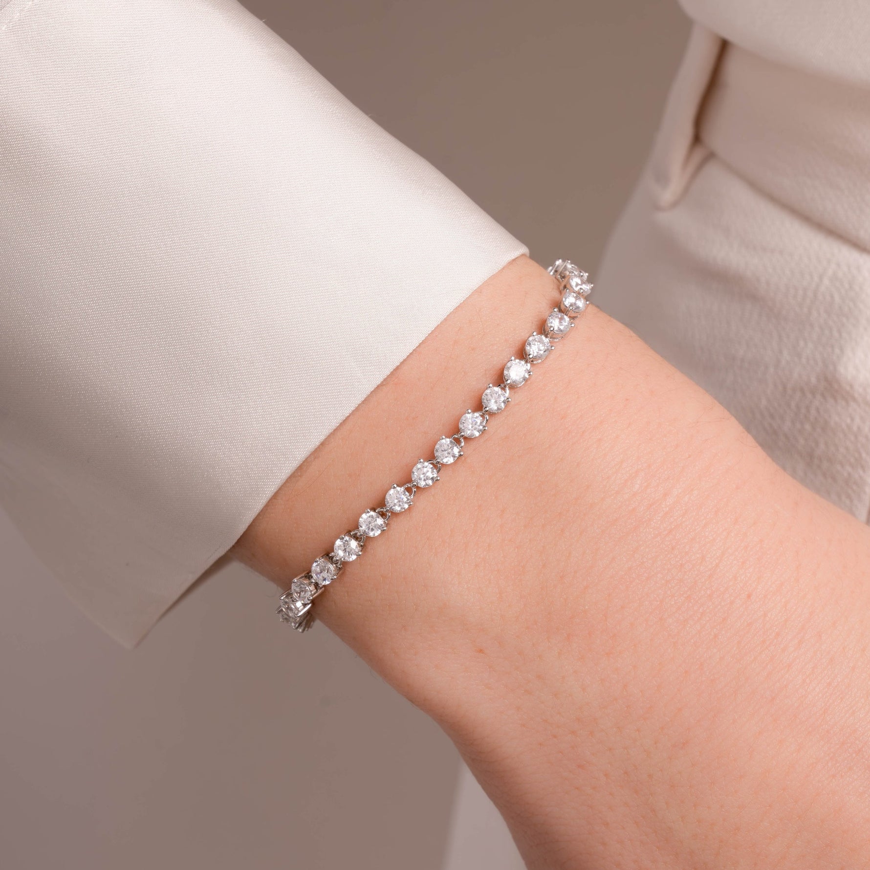 model wearing dainty silver stacking bracelet 