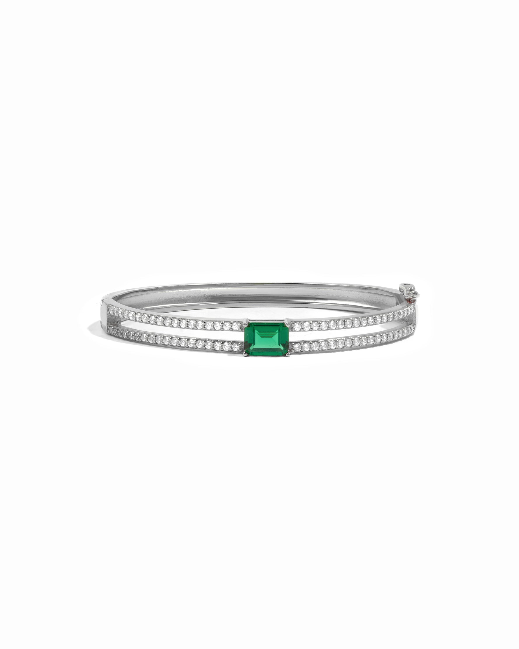 Sterling silver bracelet with a emerald green gemstone on a white background