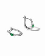 Pair of silver earrings with emerald green gemstones on a white background