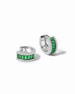 Pair of sterling silver huggie hoop earrings with green gemstones on a white background