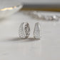Closeup image of sterling silver diamond hoop earrings