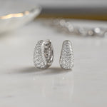 Closeup image of sterling silver diamond hoop earrings