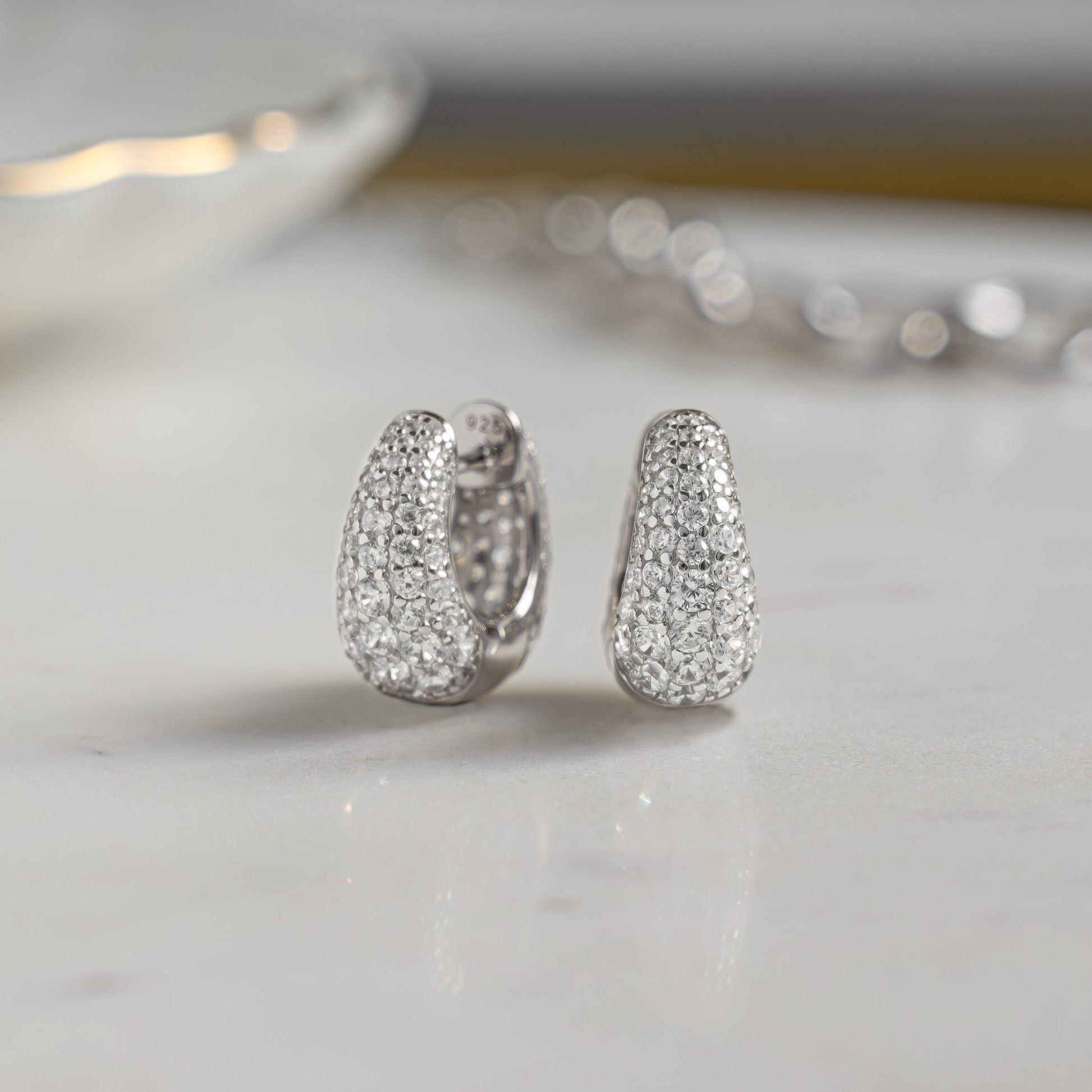 Closeup image of sterling silver diamond hoop earrings