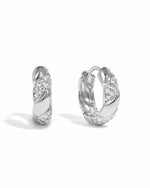 Pair of silver hoop earrings with small diamonds on a white background