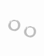 Sterling silver huggie hoops on a white background