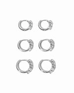 Set of silver hoop earrings on a white background
