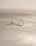 Silver dainty earrings on a neutral background