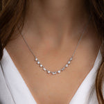 Model wearing silver necklace with dainty baguette diamonds
