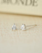 Sterling silver tiny earrings on a blurred background