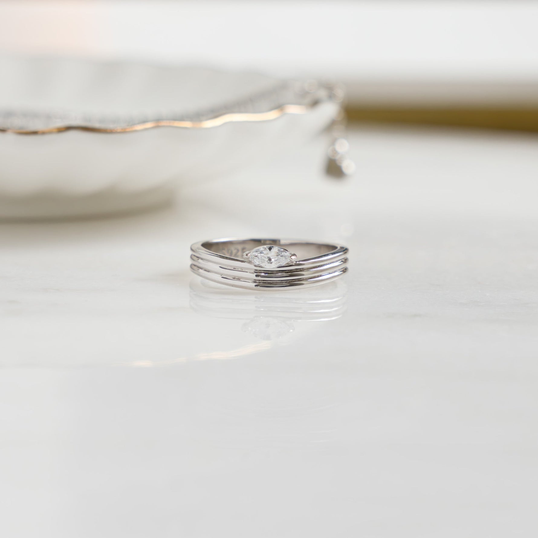 closeup image of silver stackable marquise ring