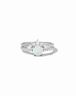 Silver ring with a opal stone and cubic zirconia diamond accents on a white background