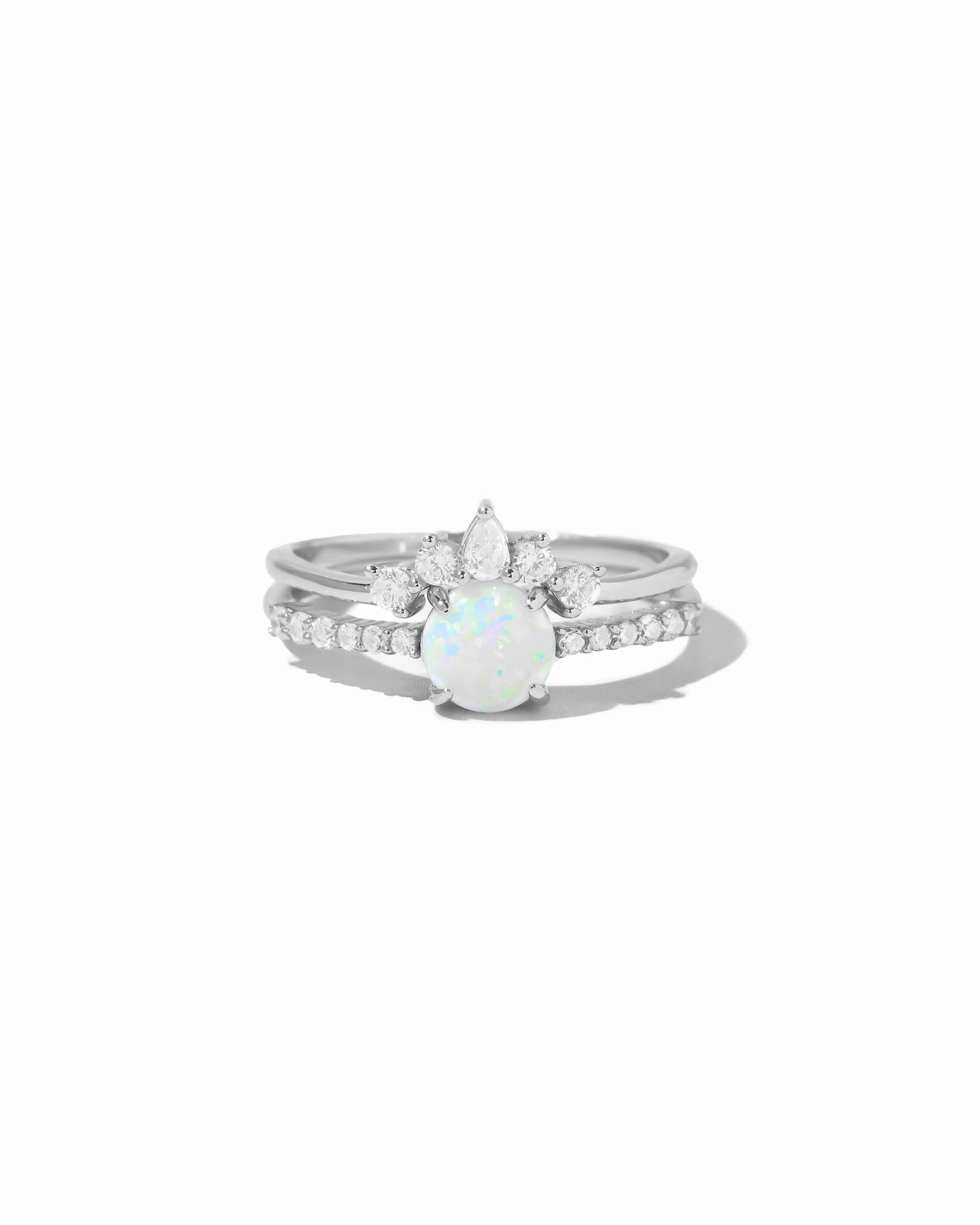 Silver ring with a opal stone and cubic zirconia diamond accents on a white background