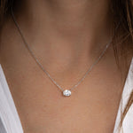 Model wearing minimalist necklace with diamond pendant