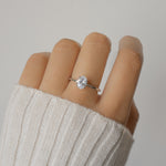 Sterling silver solitaire oval diamond ring on model.