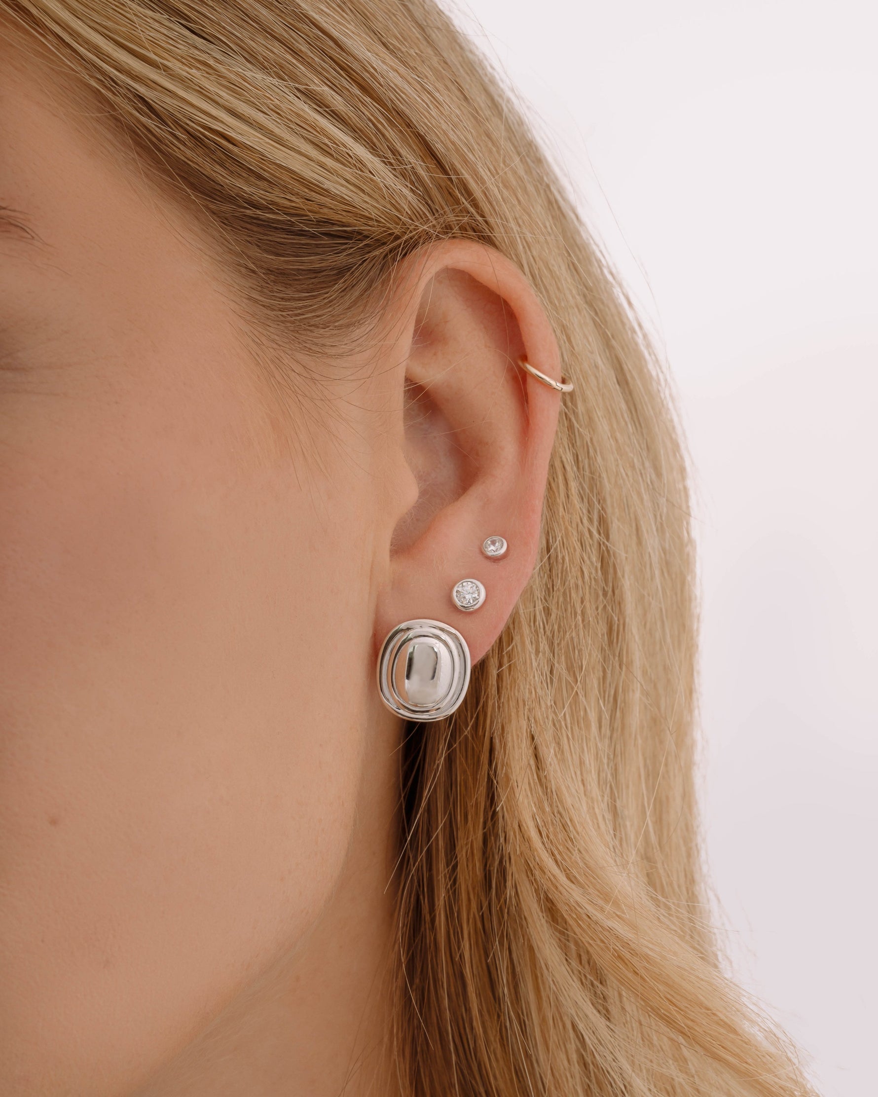 Sterling silver vintage earrings on model, followed by sterling silver diamond earrings