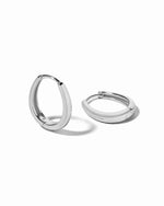 Pair of sterling silver oval hoop earrings on a white background