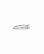 Side view of sterling silver dainty ring with cubic zirconia diamonds on a white background