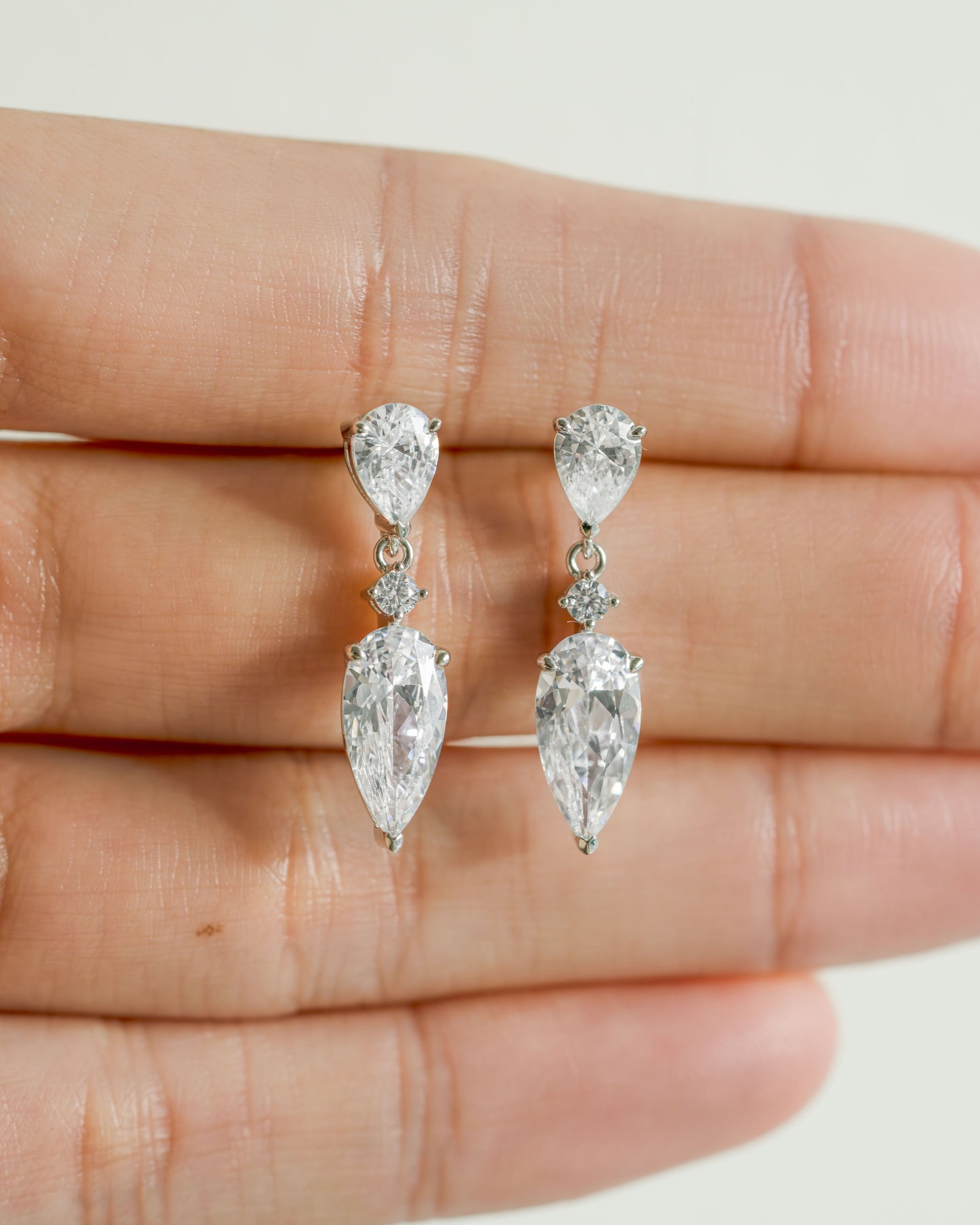 Sterling silver diamond stud with a dangling earring design