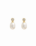 closeup image of gold drop earrings with a freshwater pearl and cubic zirconia bezel-set stone