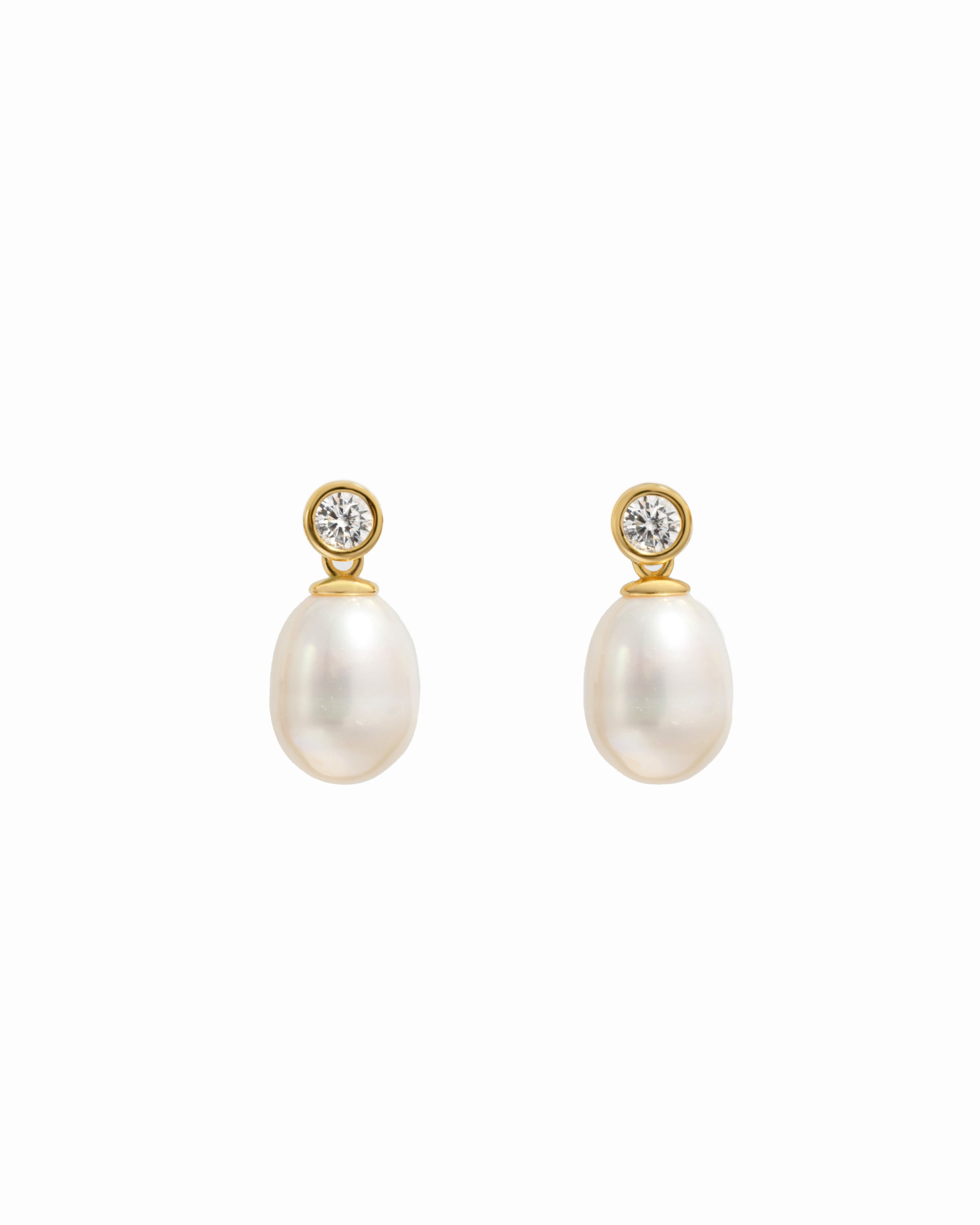 closeup image of gold drop earrings with a freshwater pearl and cubic zirconia bezel-set stone