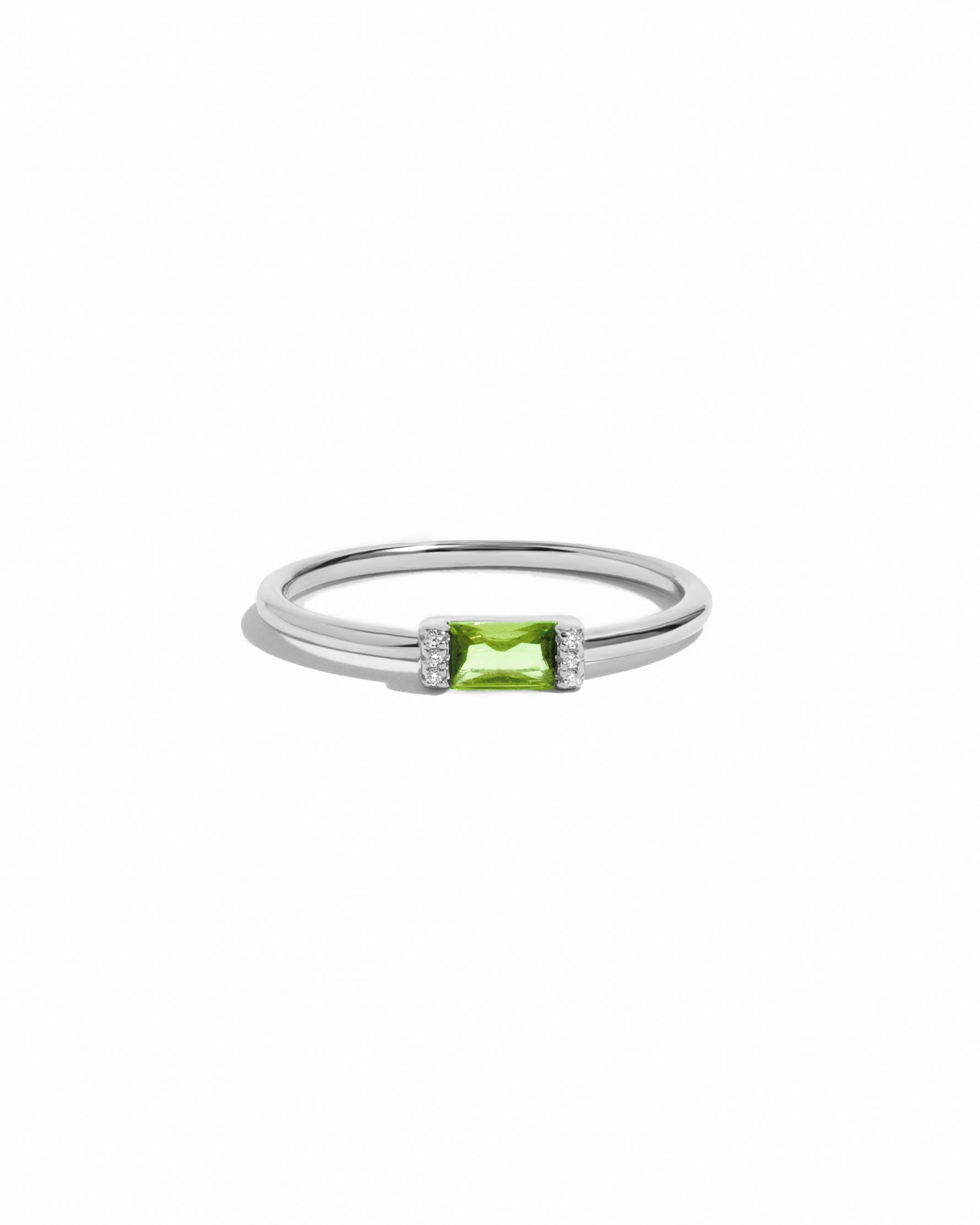 Sterling silver peridot simple baguette ring on a white background