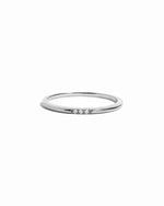 Silver ring with small diamonds on a white background