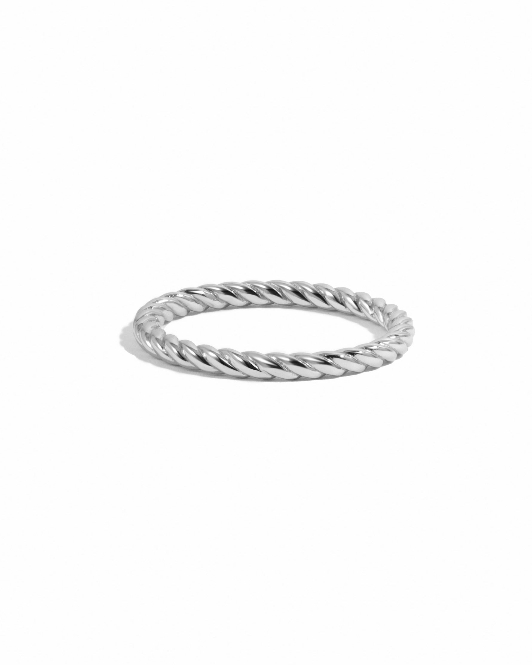 Silver twisted ring on a white background