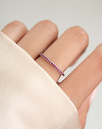 Model wearing a sterling silver ruby eternity ring