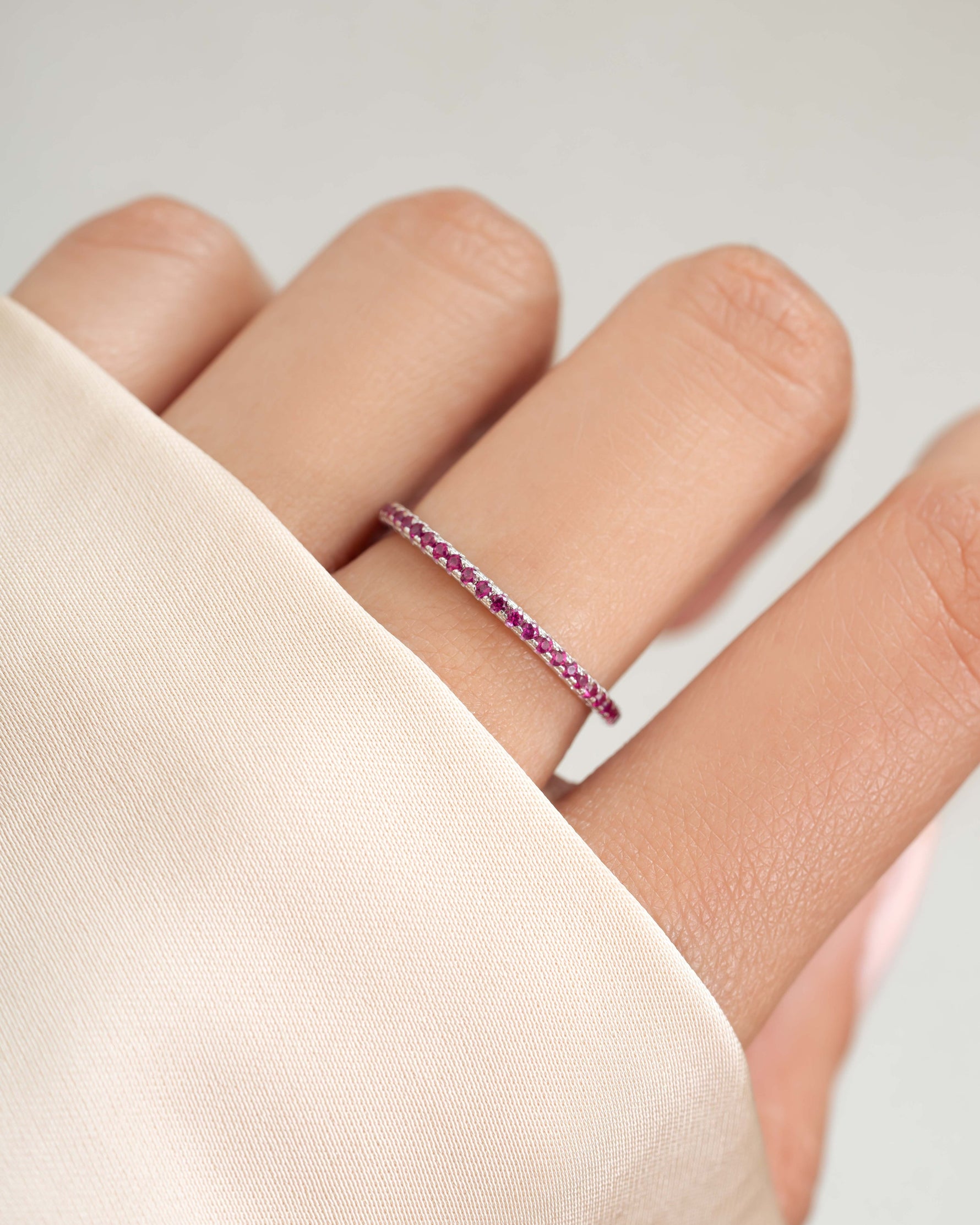Model wearing a sterling silver ruby eternity ring