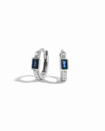 Pair of silver  small hoop earrings with sapphire gemstones on a white background