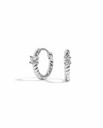 Pair of spiral silver hoop earrings with a white cubic zirconia stone on a white background