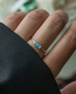 model wearing a sterling silver dainty baguette turquoise ring