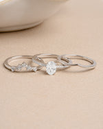 Sterling silver stackable diamond ring set on a beige background