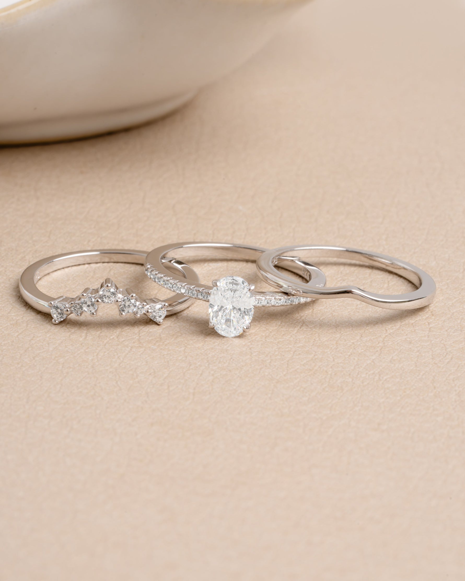 Sterling silver stackable diamond ring set on a beige background