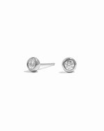 Sterling silver dainty stud earrings on a white background