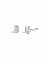 Pair of silver tiny stud earrings with baguette cut stones on a white background