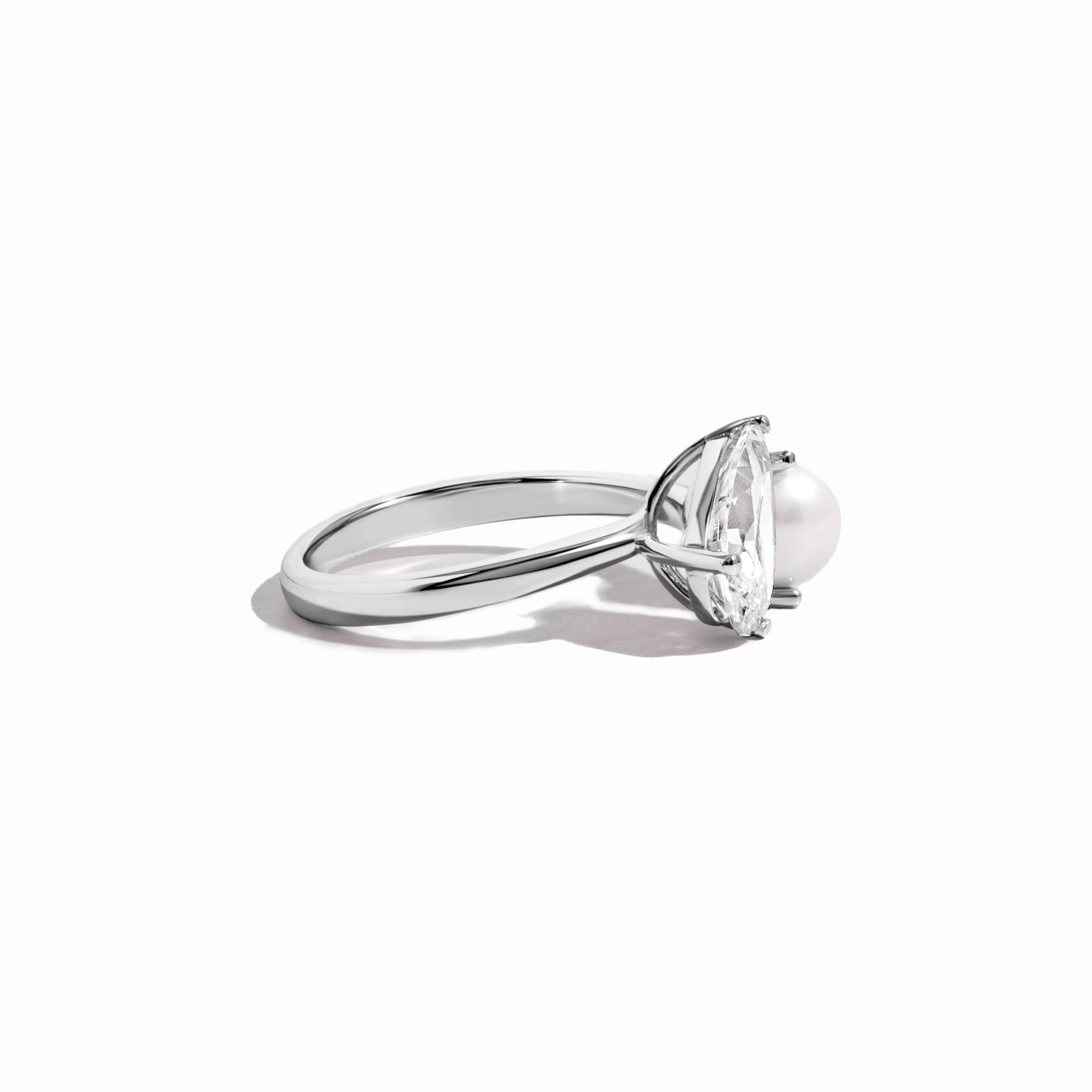 side view of silver pearl and pear cut cz ring