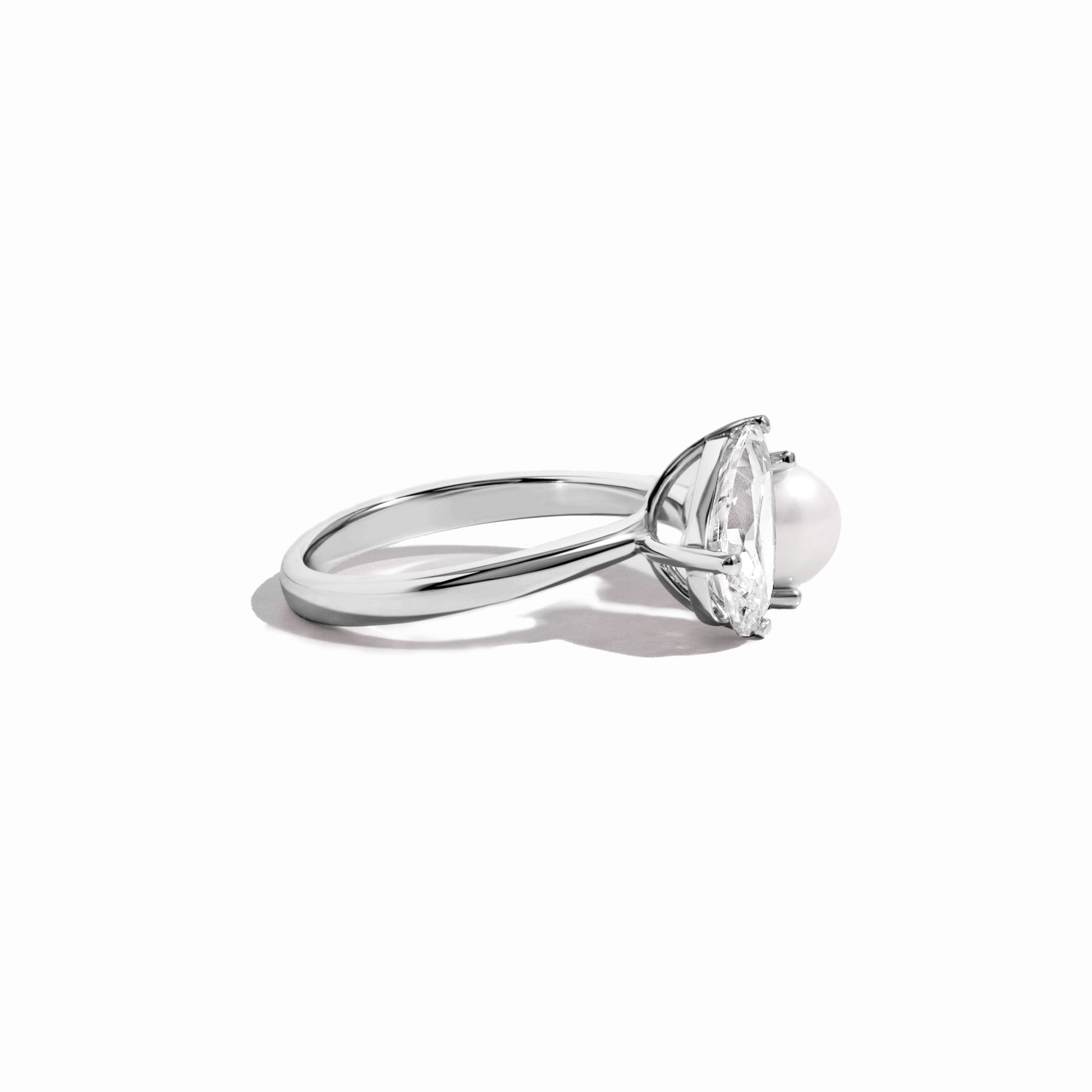 side view of silver pearl and pear cut cz ring