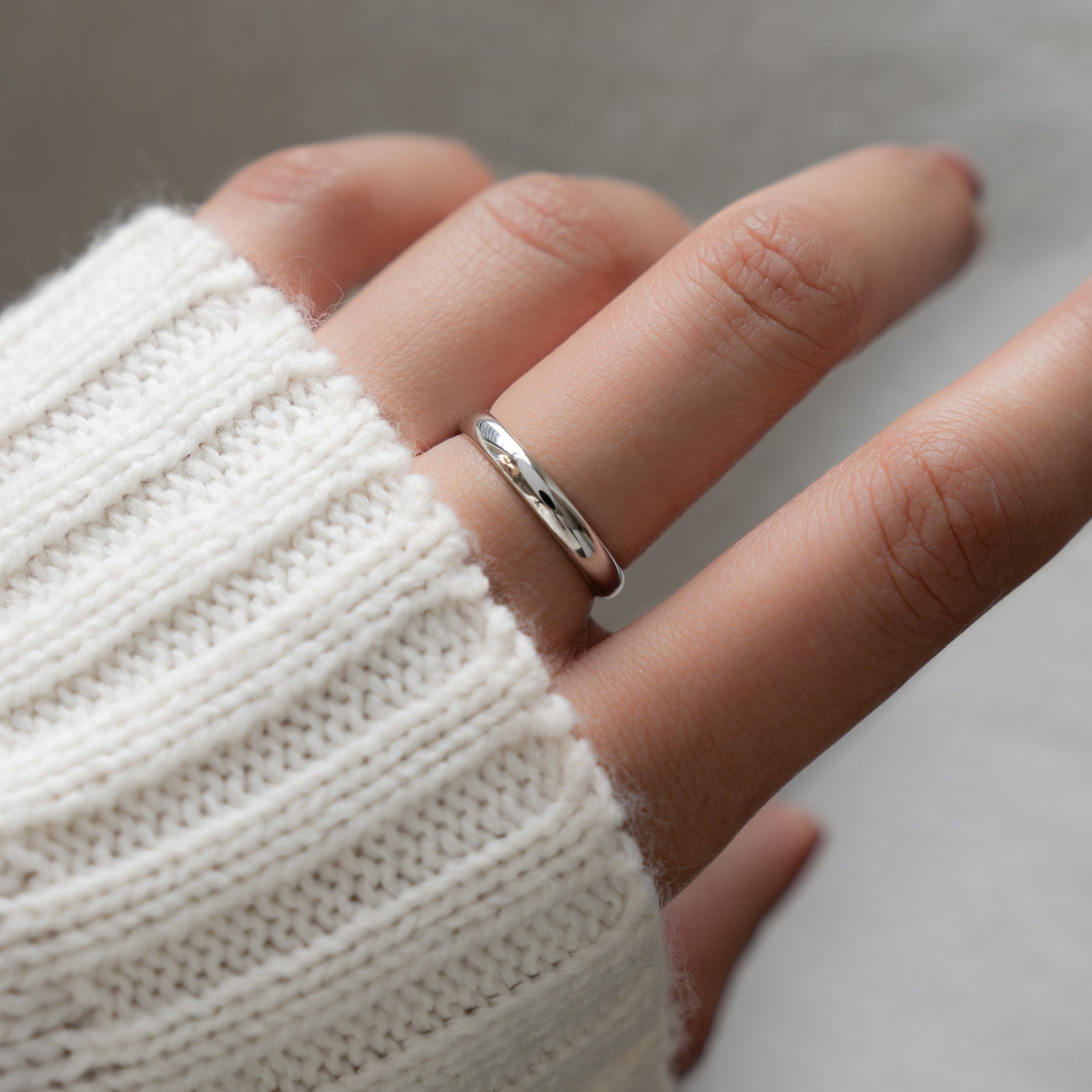 Model wearing a dainty ring  in silver that feels like a gentle hug around the finger.