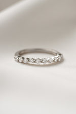 Sterling silver promise ring on plain background 