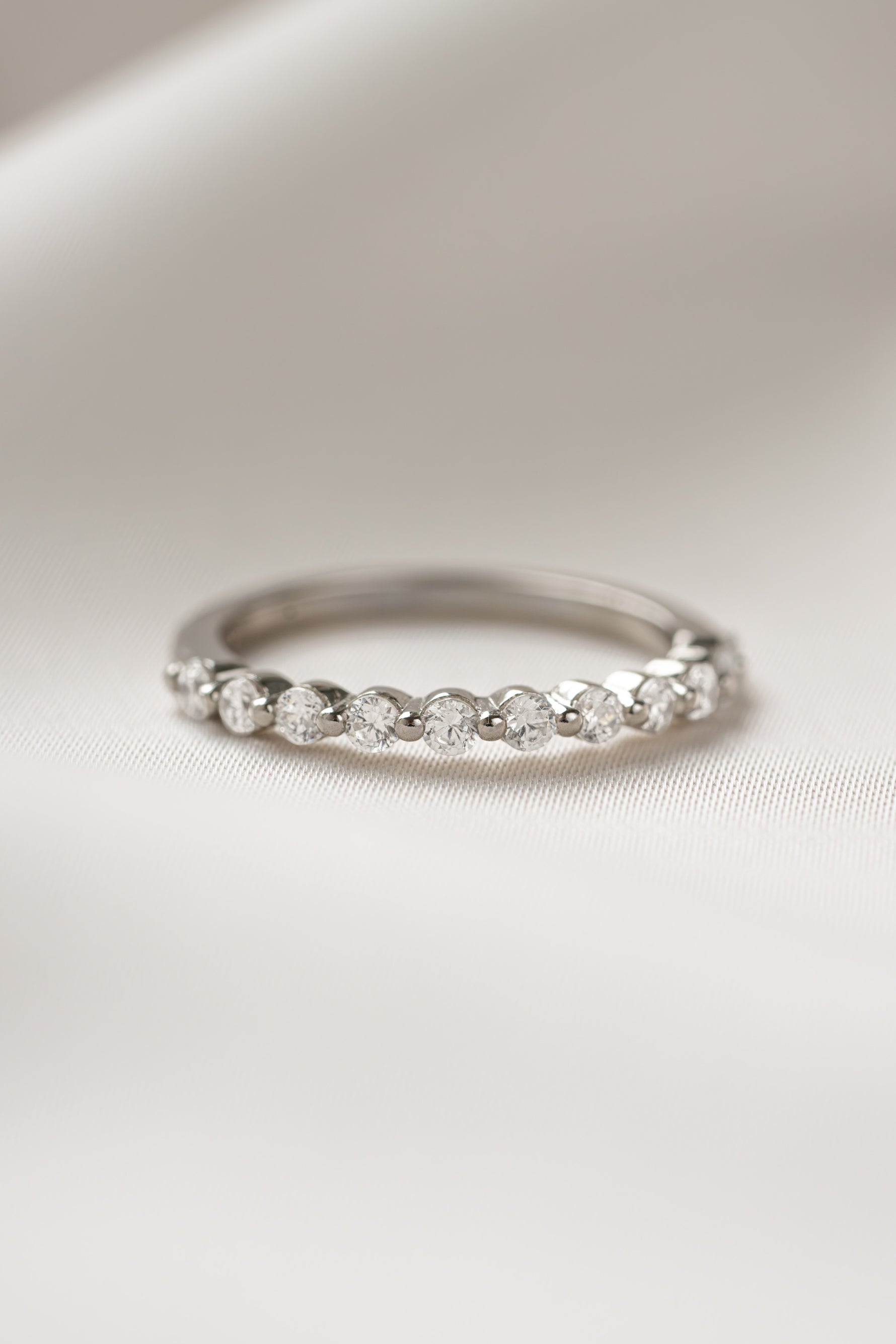 Sterling silver promise ring on plain background 